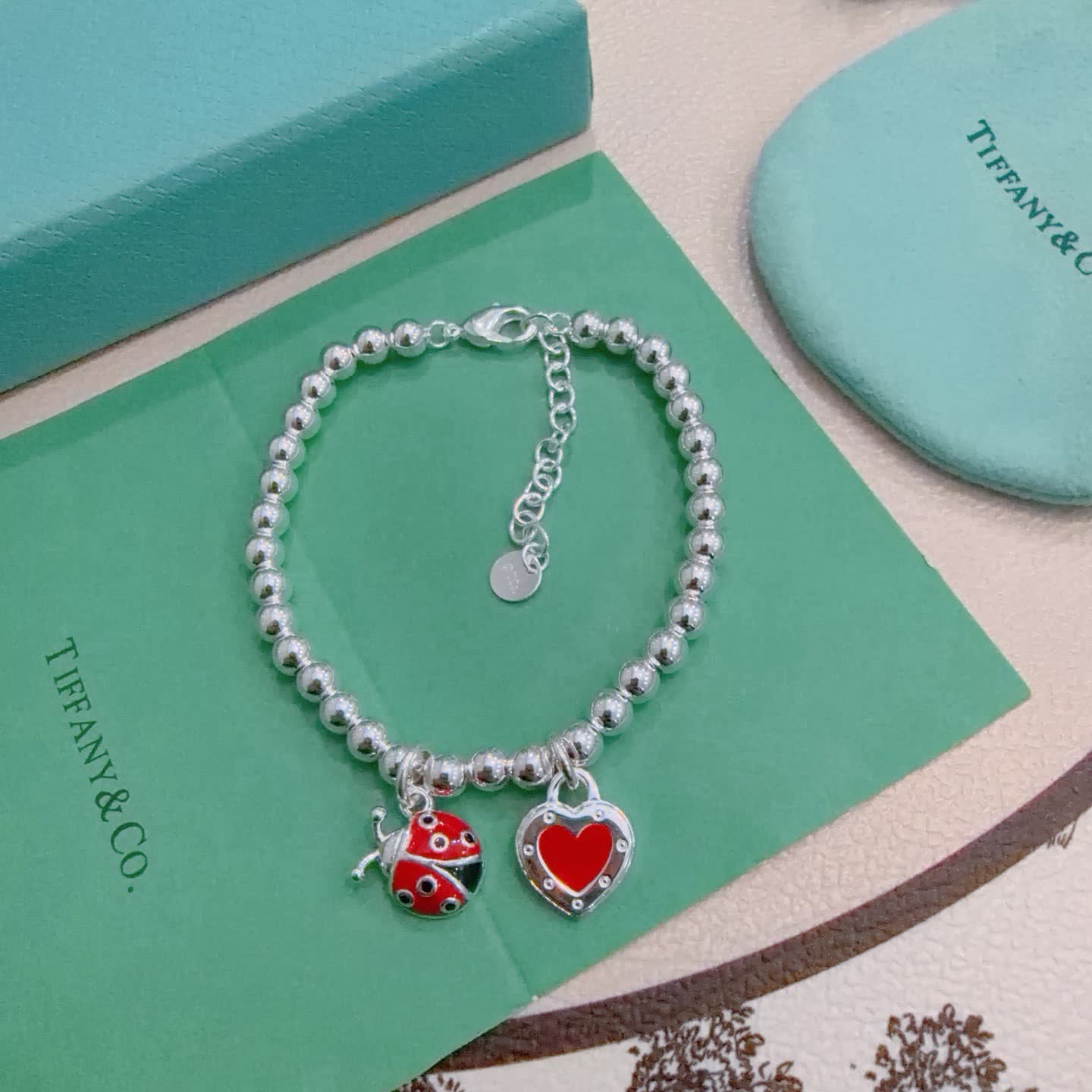 Tiffany & Co. Silver Bead Bracelet with Ladybug and Heart Charms